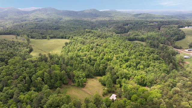 aerial view of a heavily wooded area and mountains