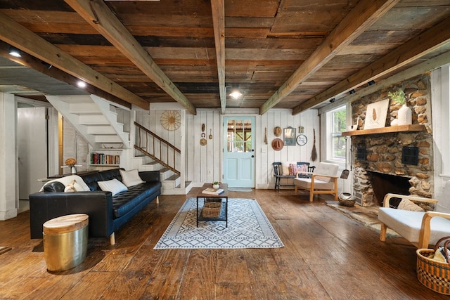 living room featuring wooden ceiling, hardwood / wood-style floors, stairway, and beamed ceiling