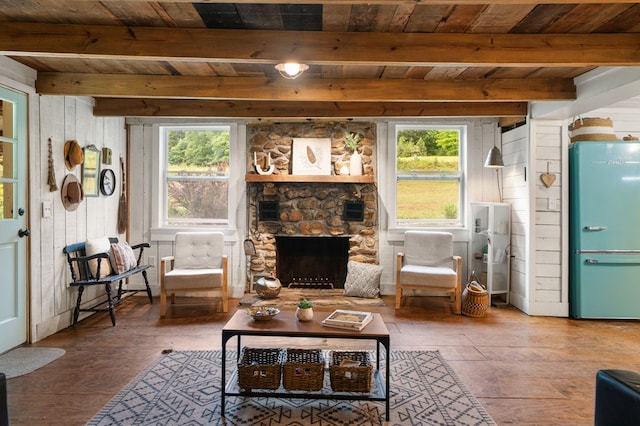 living room featuring wood ceiling, hardwood / wood-style flooring, healthy amount of natural light, beam ceiling, and a fireplace