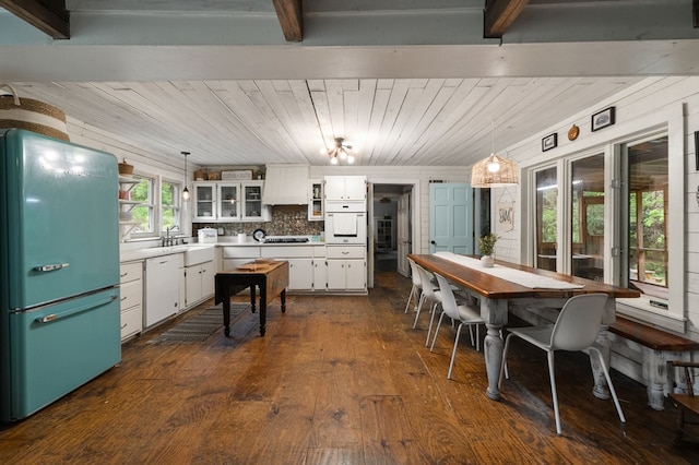kitchen with white appliances, dark wood-style floors, open shelves, white cabinetry, and a sink