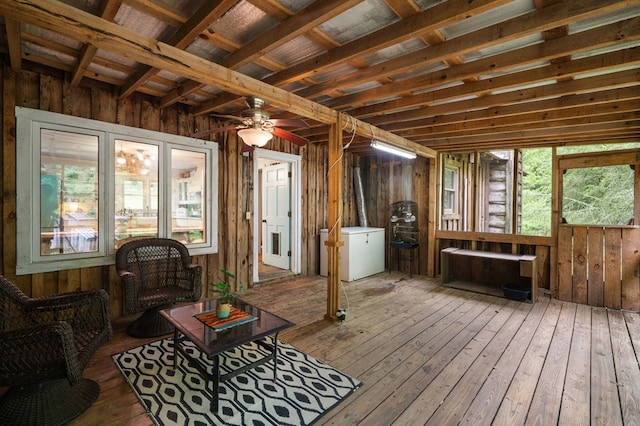 sunroom / solarium featuring ceiling fan and an outdoor hangout area