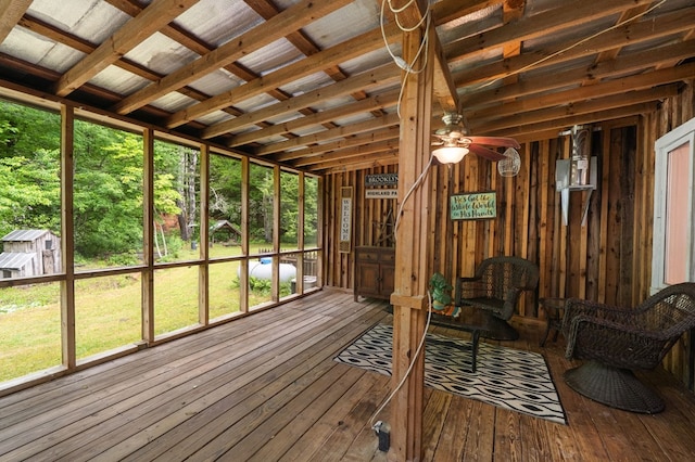 unfurnished sunroom with ceiling fan and plenty of natural light