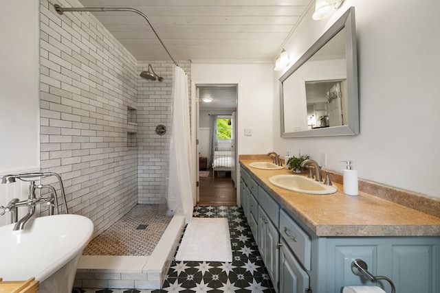 bathroom featuring a shower stall, tile patterned floors, and double vanity