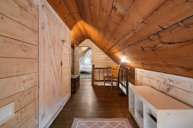 additional living space with vaulted ceiling, wood walls, hardwood / wood-style floors, and wood ceiling