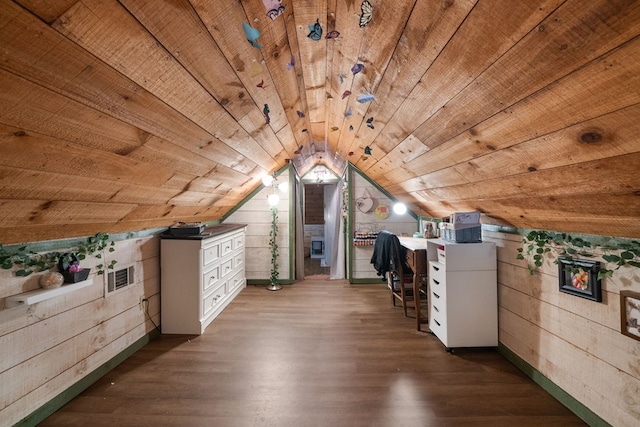 additional living space with wood walls, wooden ceiling, wood finished floors, vaulted ceiling, and baseboards