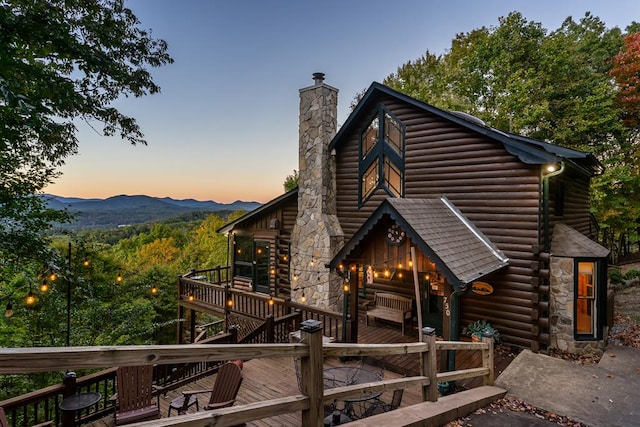 view of front of property featuring a deck with mountain view