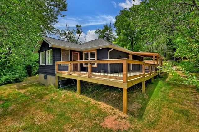 rear view of property with a yard and a deck