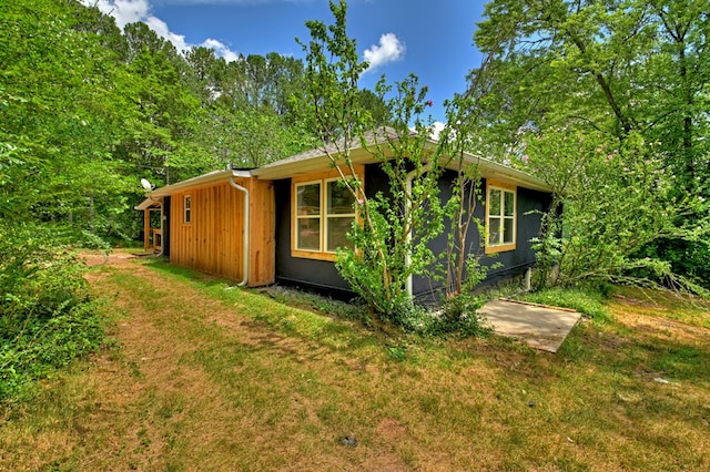 view of property exterior with a lawn