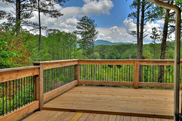 wooden deck featuring a mountain view and a wooded view