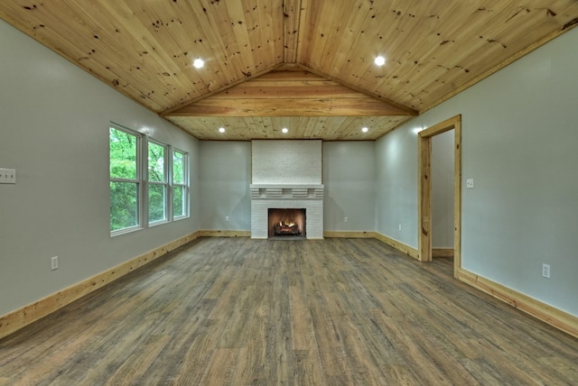 unfurnished living room featuring recessed lighting, lofted ceiling, wood finished floors, baseboards, and a large fireplace