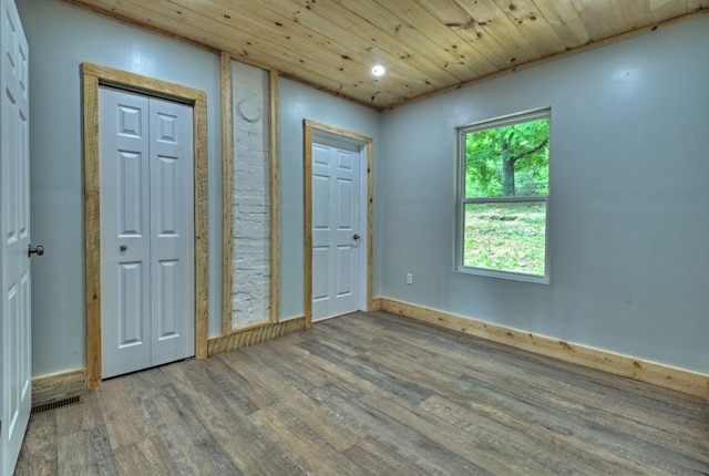 foyer entrance with wooden ceiling and wood finished floors