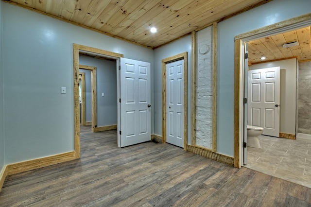 foyer entrance with baseboards, wooden ceiling, wood finished floors, and recessed lighting