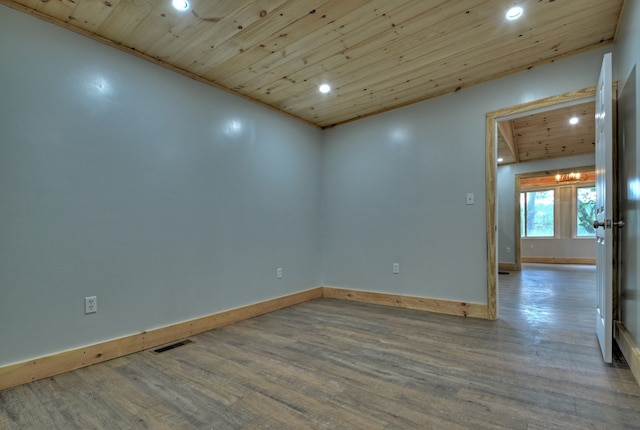 empty room featuring baseboards, visible vents, recessed lighting, wood finished floors, and wooden ceiling
