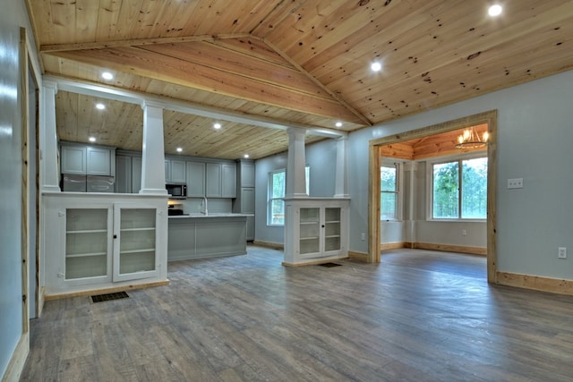 unfurnished living room featuring recessed lighting, plenty of natural light, wooden ceiling, and decorative columns