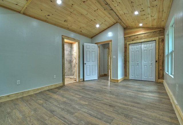 unfurnished bedroom featuring recessed lighting, vaulted ceiling, baseboards, and wood finished floors