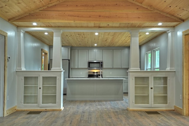 kitchen featuring wood ceiling, decorative columns, and appliances with stainless steel finishes