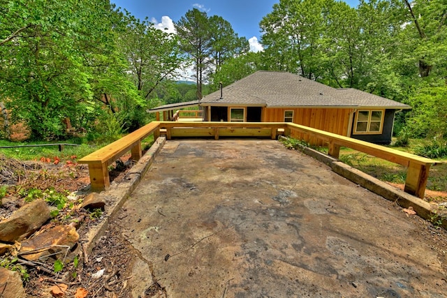 view of front of property with roof with shingles and board and batten siding