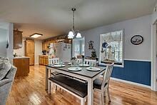 dining room featuring a notable chandelier and light wood-type flooring