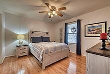 bedroom with light wood-type flooring and ceiling fan