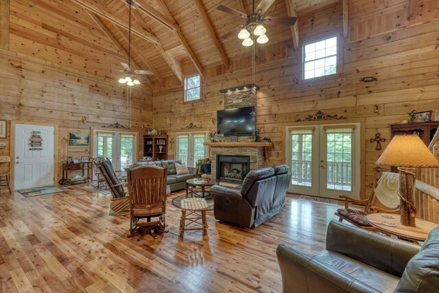 interior space with beamed ceiling, wood walls, wood-type flooring, and wooden ceiling