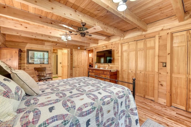 bedroom featuring wooden ceiling, light hardwood / wood-style floors, beamed ceiling, and wood walls