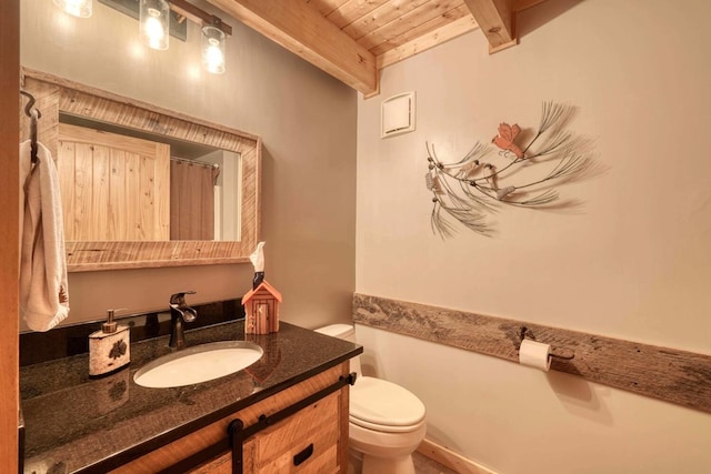 bathroom with beamed ceiling, vanity, wood ceiling, and toilet