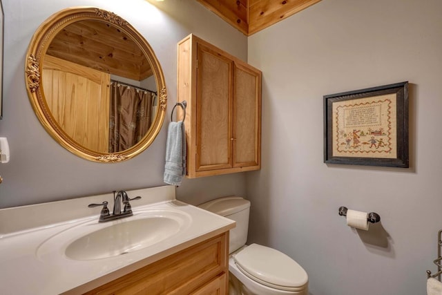 bathroom featuring vanity, toilet, and a shower with shower curtain