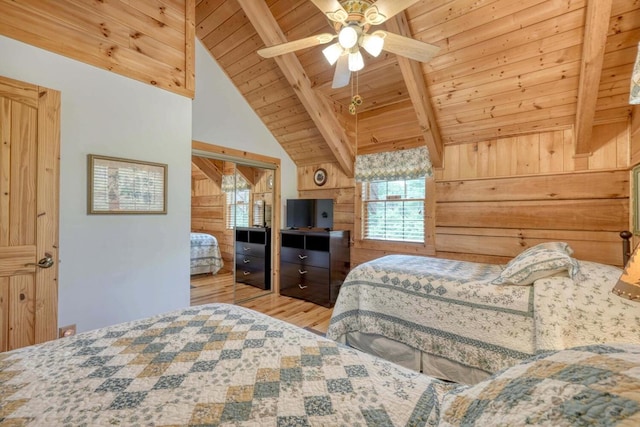 bedroom with wood ceiling, wooden walls, light hardwood / wood-style floors, and lofted ceiling with beams