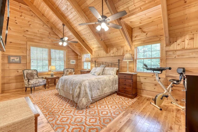 bedroom featuring multiple windows, light hardwood / wood-style flooring, beamed ceiling, and wood walls