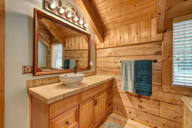 bathroom featuring vanity, lofted ceiling, wooden ceiling, and wood walls