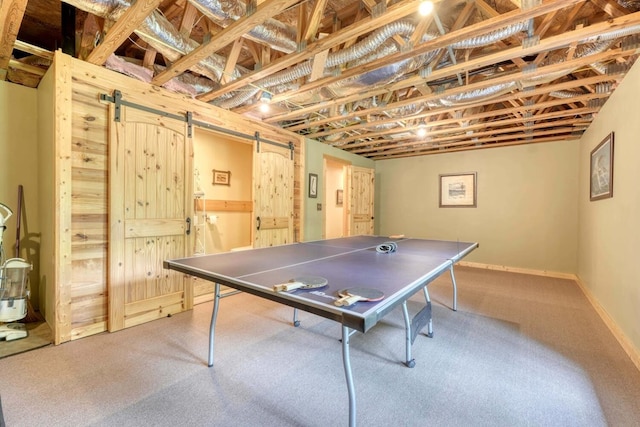 playroom featuring carpet floors and a barn door