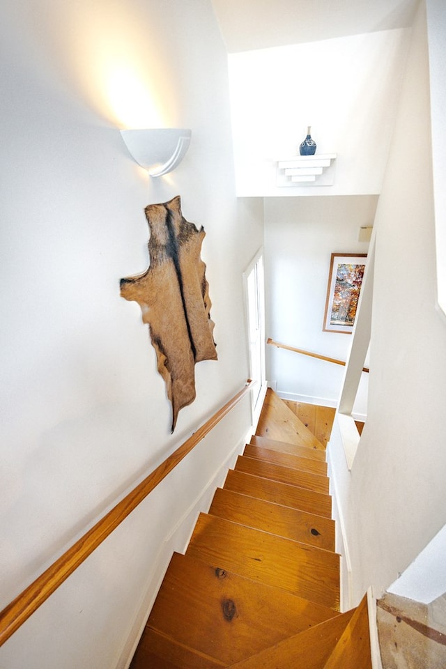 stairs featuring hardwood / wood-style floors