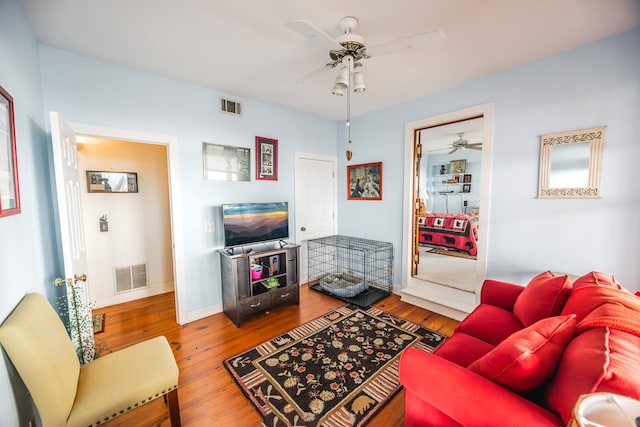 living room with hardwood / wood-style floors and ceiling fan