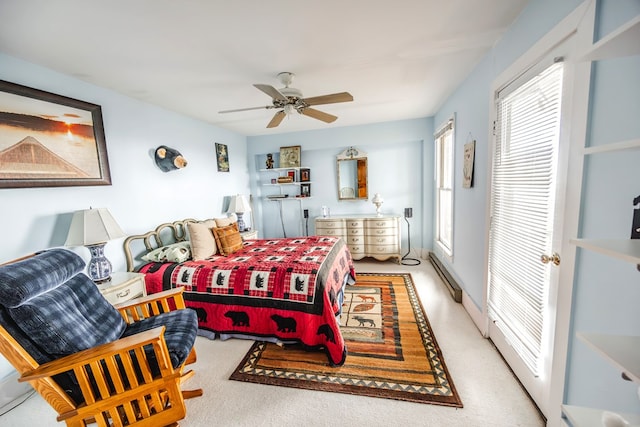 bedroom with ceiling fan and baseboard heating