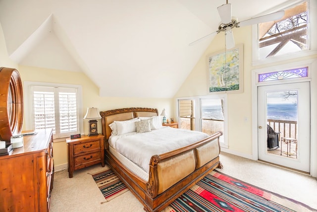 bedroom with lofted ceiling, access to exterior, and light carpet