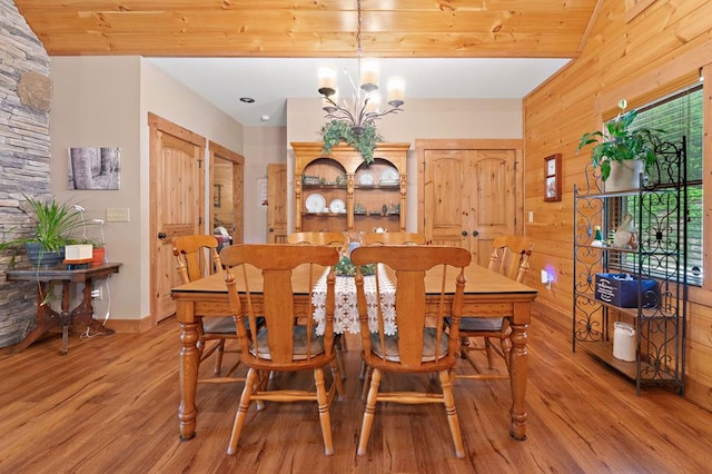 1172 Settlers Ridge Rd, Ellijay, GA 30540 - dining room featuring light wood-type flooring, wood walls, a chandelier, and baseboards