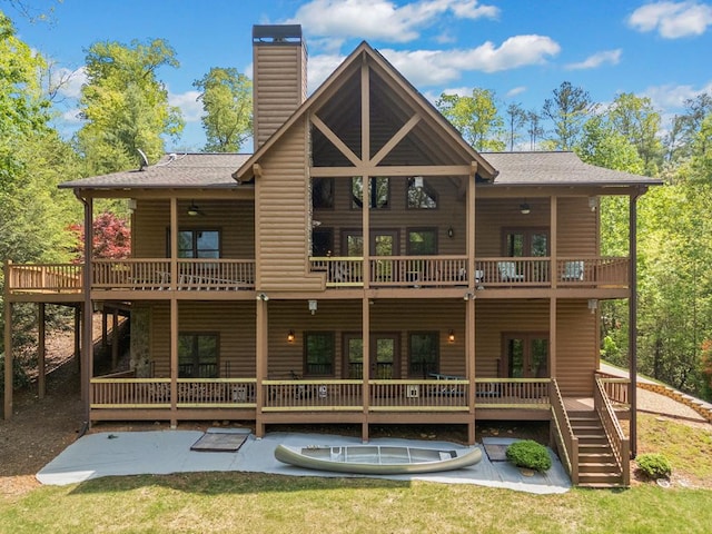 1172 Settlers Ridge Rd, Ellijay, GA 30540 - back of property with log veneer siding, french doors, a patio area, a chimney, and a balcony