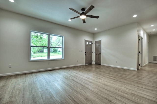 unfurnished living room featuring a ceiling fan, recessed lighting, wood finished floors, and visible vents