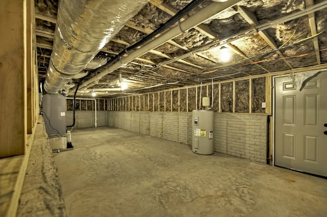 unfinished below grade area with heating unit and electric water heater
