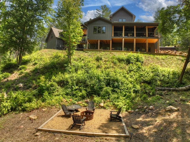 back of house with an outdoor fire pit