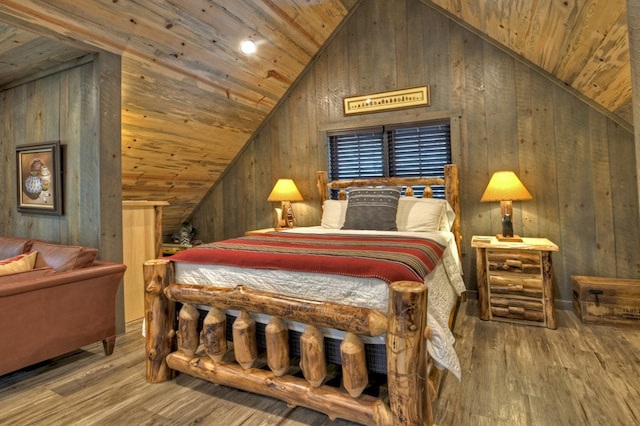 bedroom with vaulted ceiling, wood ceiling, light hardwood / wood-style floors, and wood walls