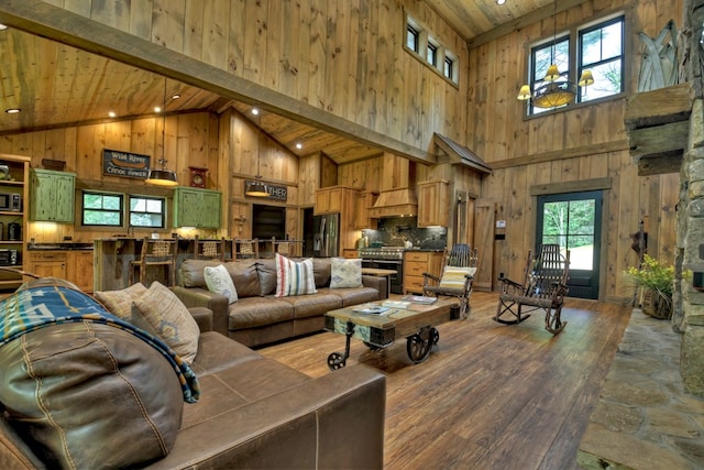 living room with high vaulted ceiling, wood-type flooring, wooden ceiling, beamed ceiling, and wood walls