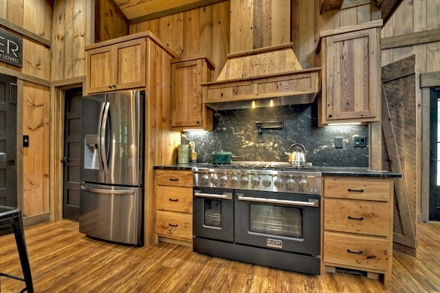 kitchen featuring tasteful backsplash, wood-type flooring, and stainless steel appliances