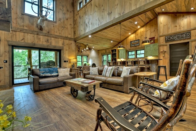 living room with hardwood / wood-style floors, plenty of natural light, and wood walls