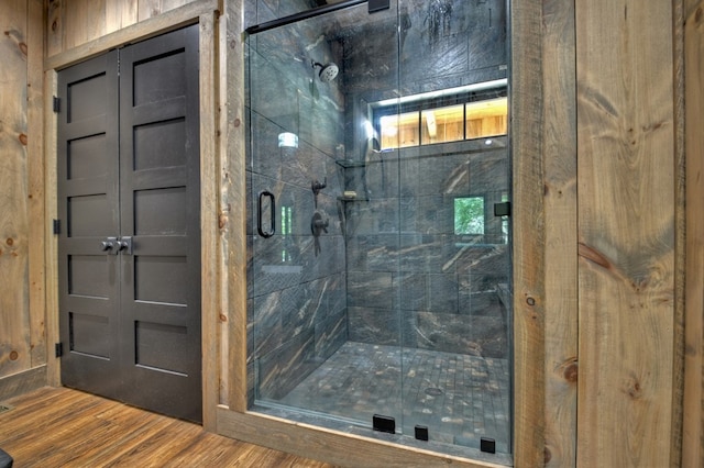 bathroom featuring a shower with door and hardwood / wood-style floors