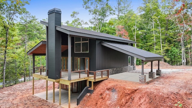 view of side of property with a patio area and a deck