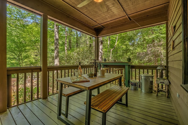 wooden deck with a ceiling fan and outdoor dining space