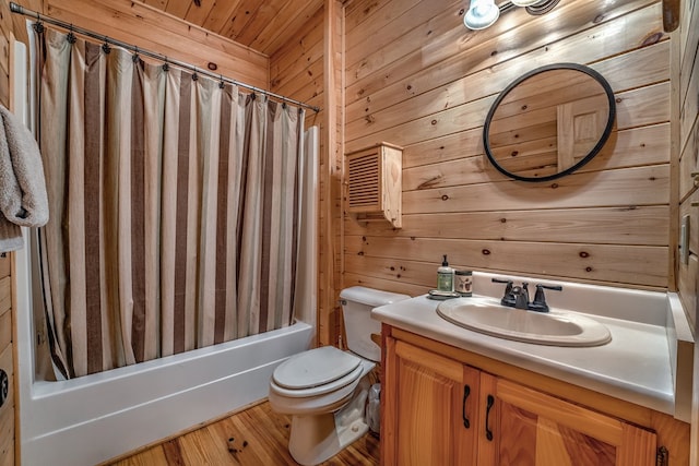 bathroom with wooden ceiling, toilet, wooden walls, wood finished floors, and vanity