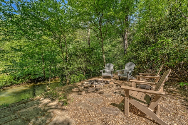 view of patio featuring a water view and an outdoor fire pit