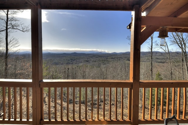 deck with a mountain view and a view of trees